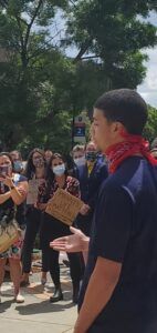 Young African American man addressing protesters